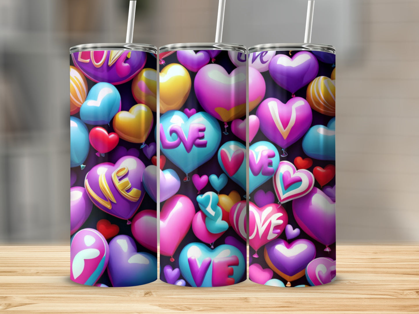 Three heart-shaped balloon tumblers with the word "love" written on them.