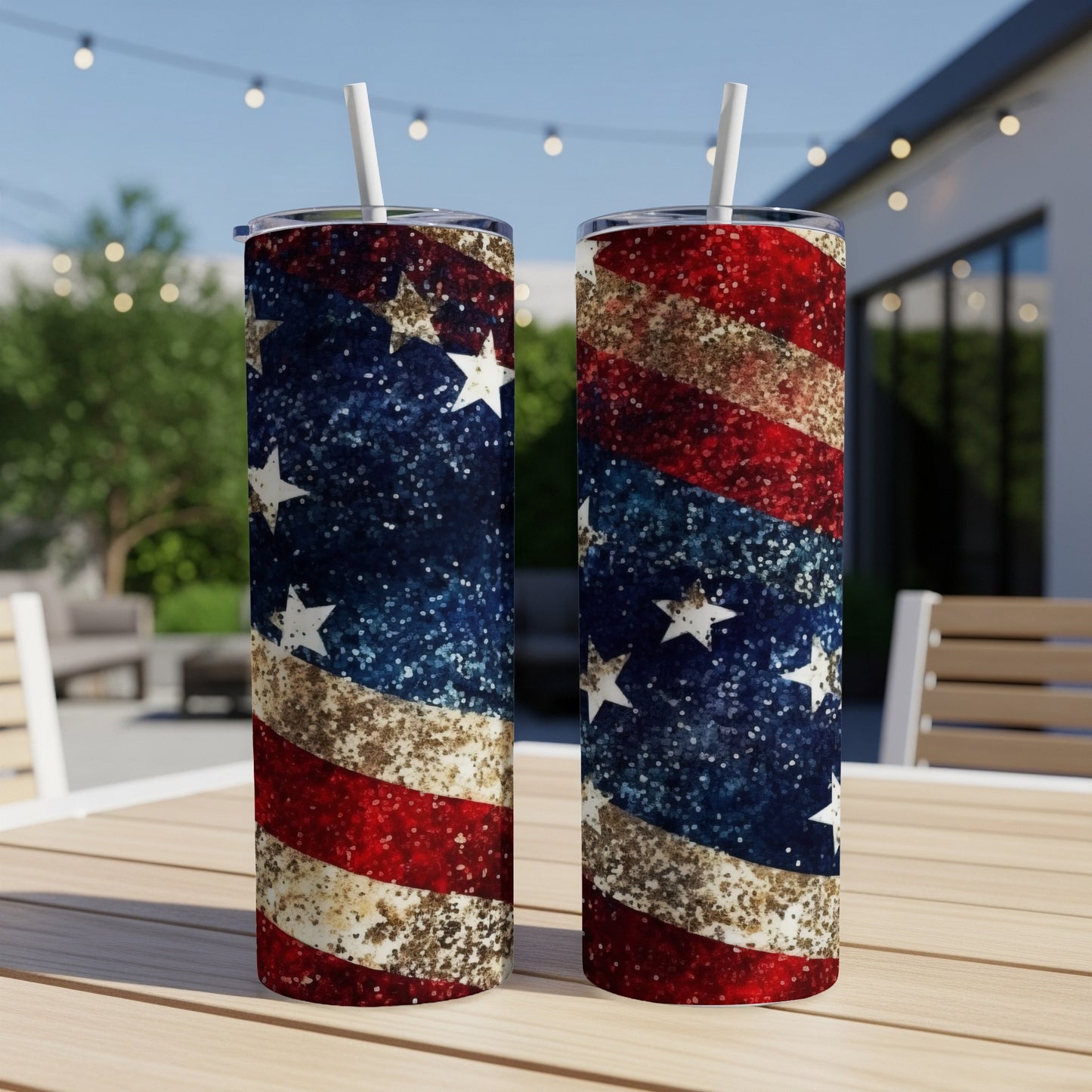 Two patriotic glitter tumblers with stars and stripes design on outdoor table.