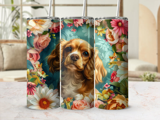 Brown and white dog surrounded by colorful flowers, on a cylindrical tumbler.