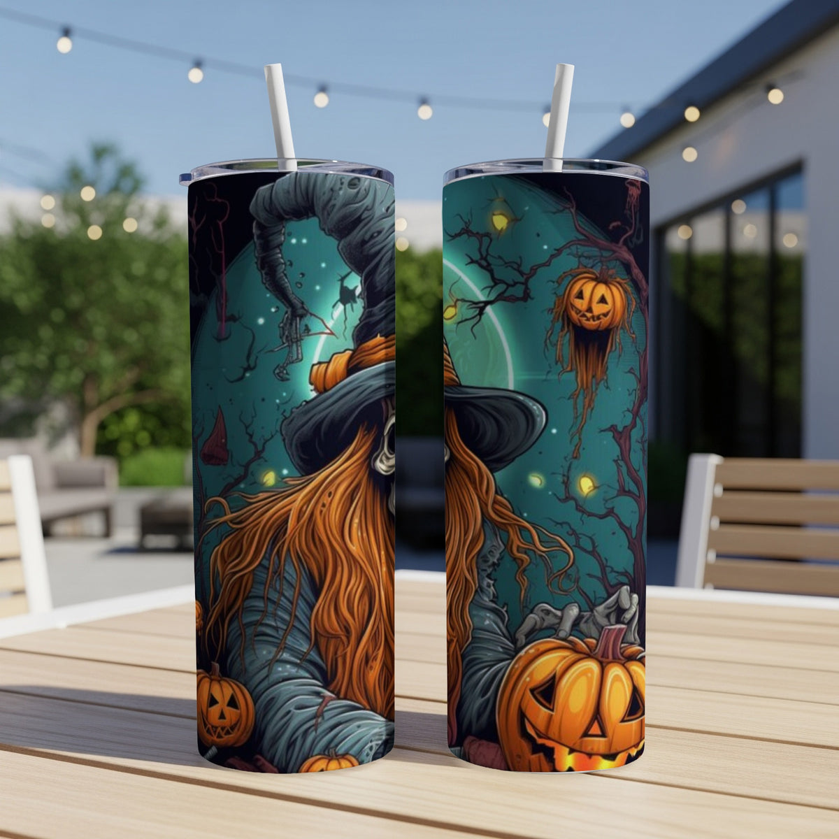 Two tumblers with Halloween witch and pumpkin art on a table.
