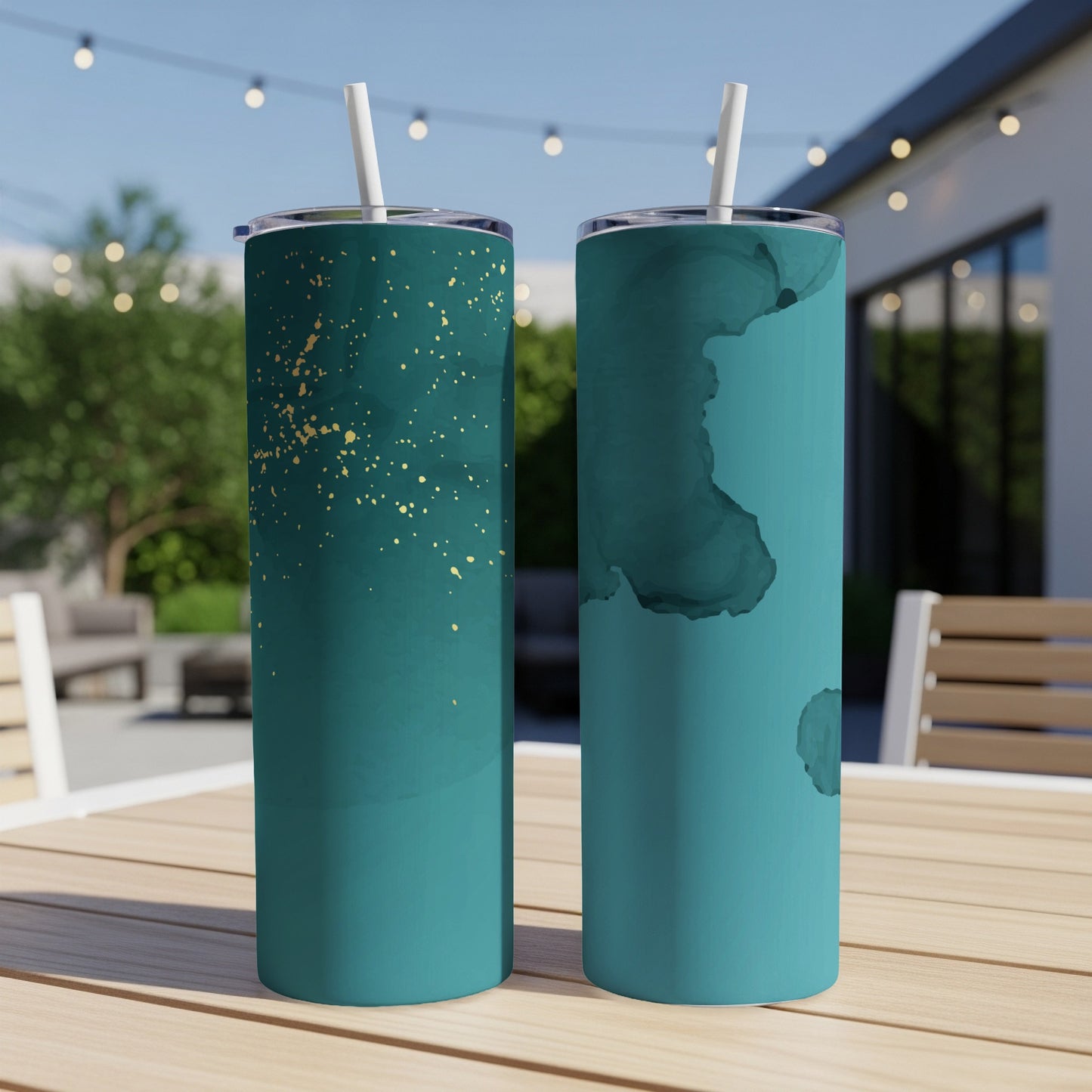 Two teal tumblers with gold splatters and abstract ink designs.