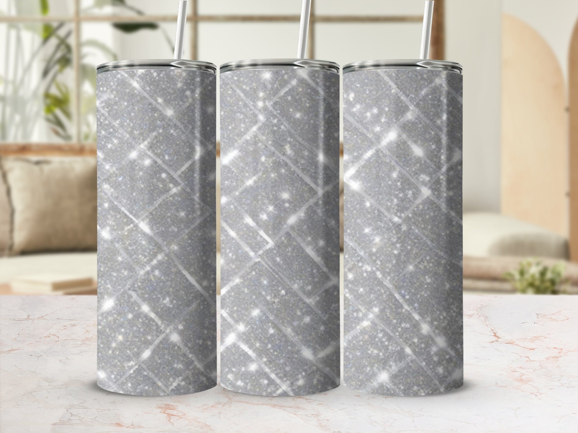 Three glittery silver tumblers with striped patterns.