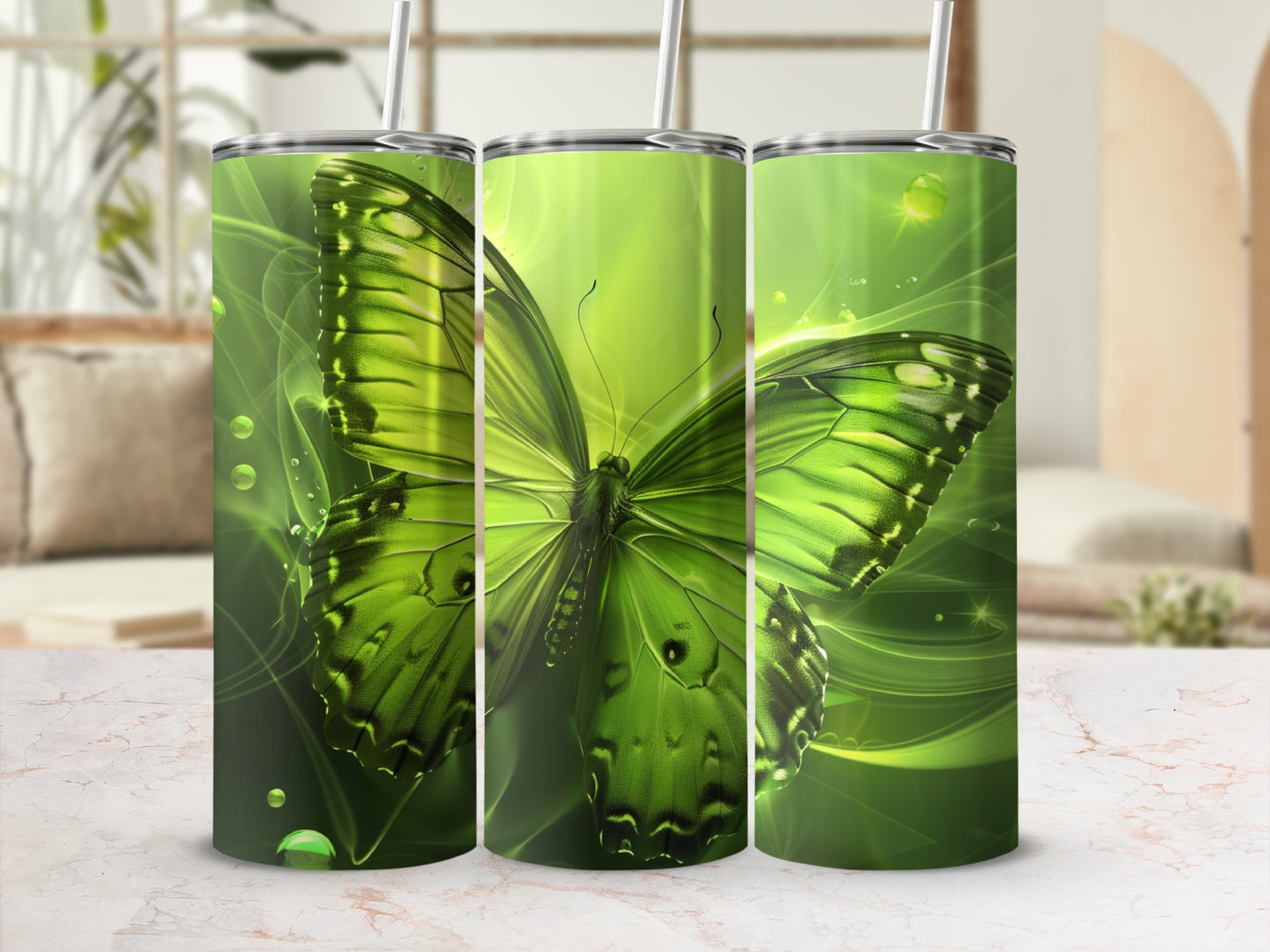 Green butterfly design on three tumblers with straw.