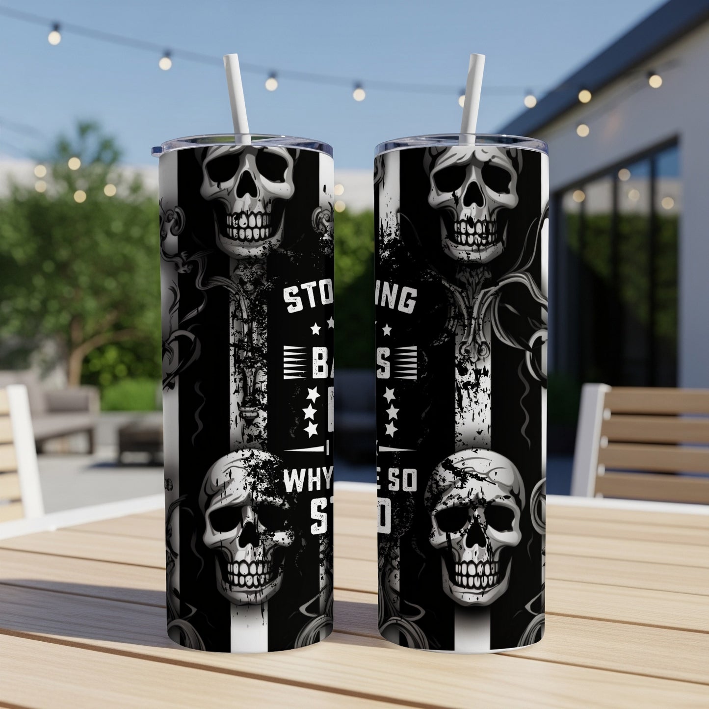Two black and white tumblers with skull graphics, featuring text "STOP BEING SO SAD".