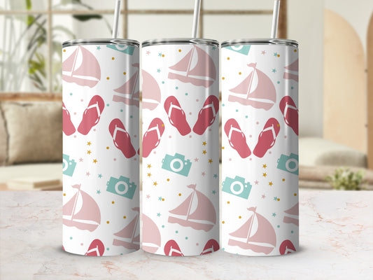 White tumbler with sailboat, flip-flop, and camera pattern.