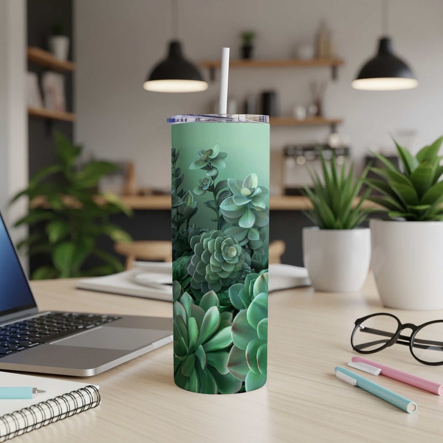 Green succulent plants pattern on a mint green skinny tumbler with a straw.