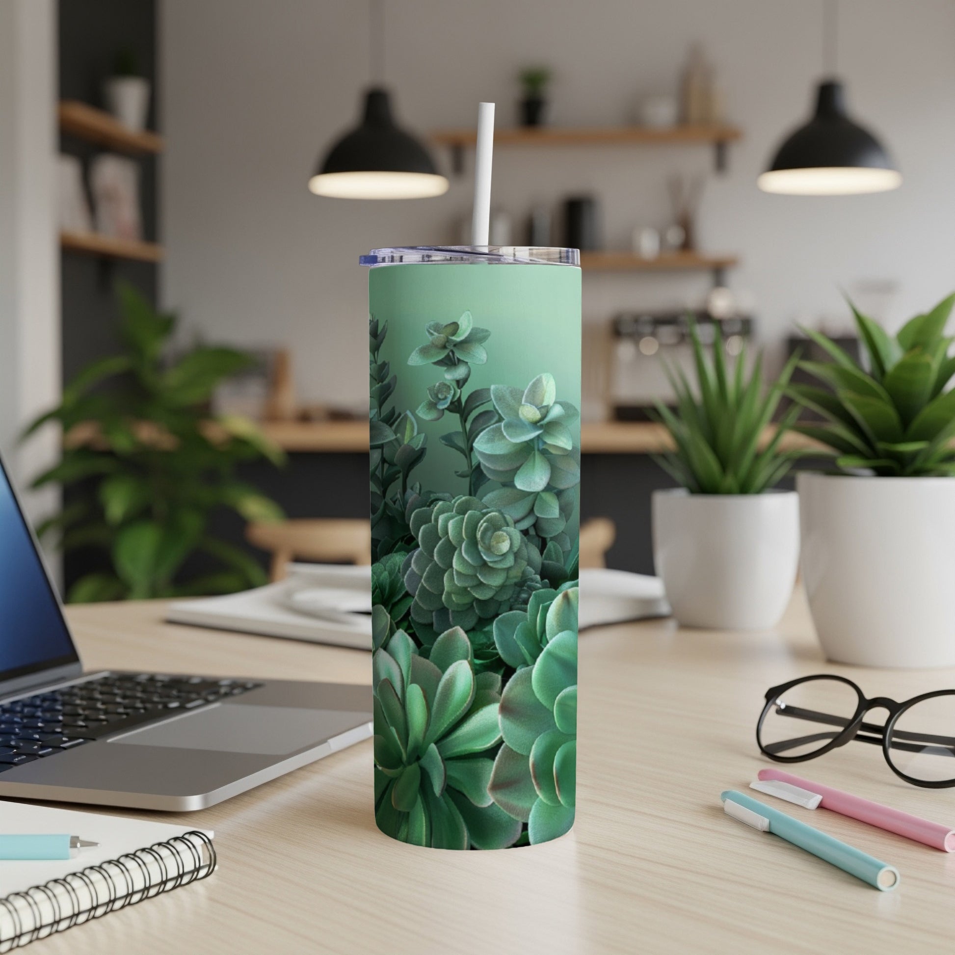 Green succulent plants pattern on a mint green skinny tumbler with a straw.