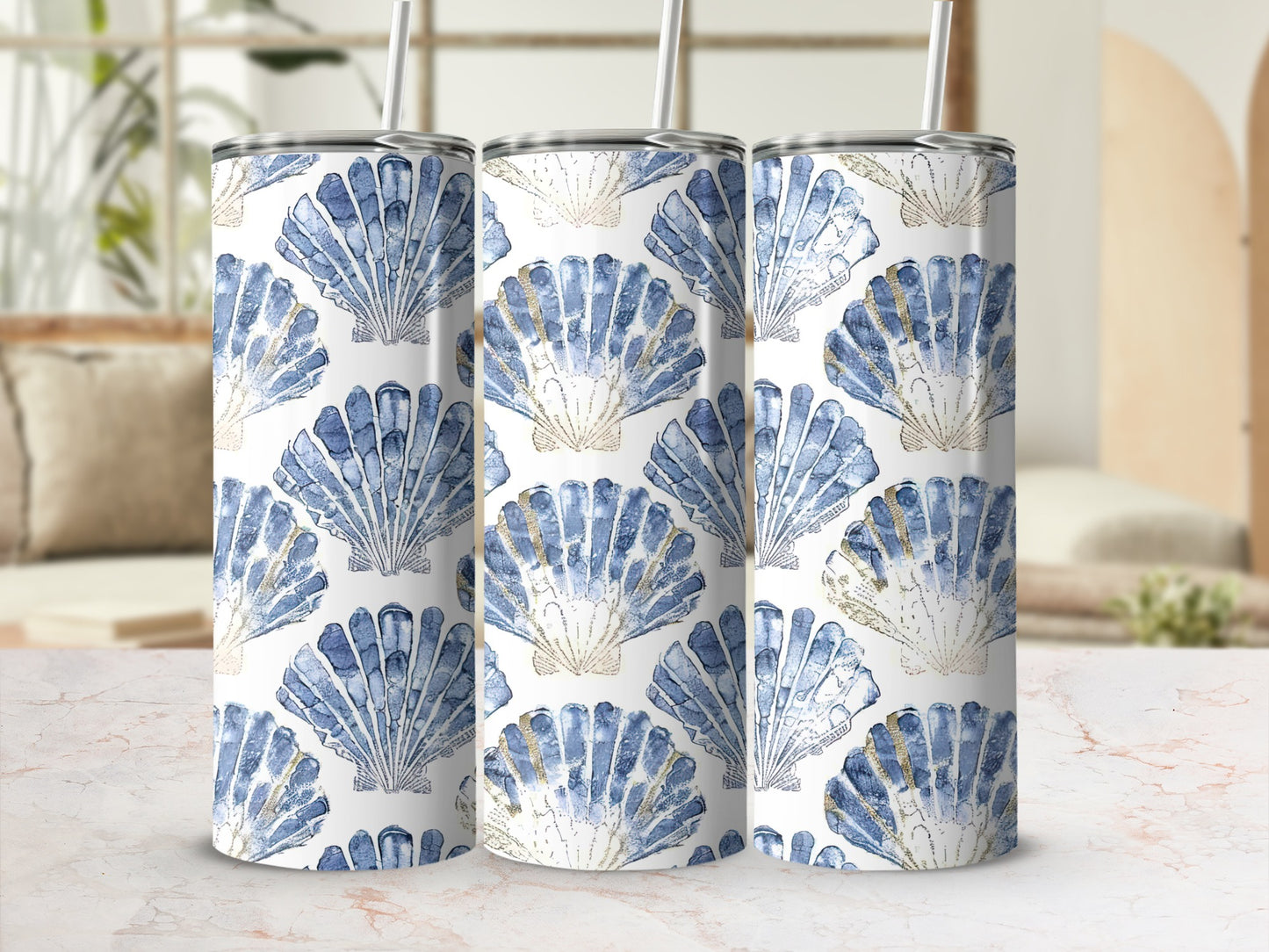 Three tumblers with a blue and gold seashell pattern.
