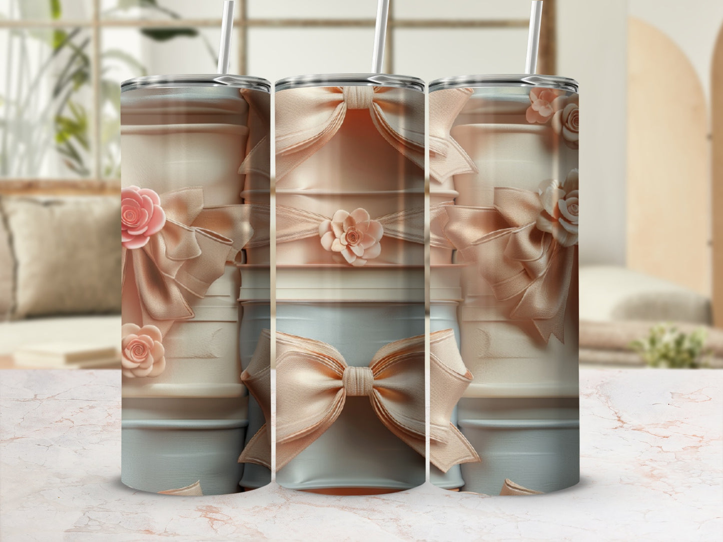 Three pastel tumblers with bow and floral accents, displayed on a marble surface.