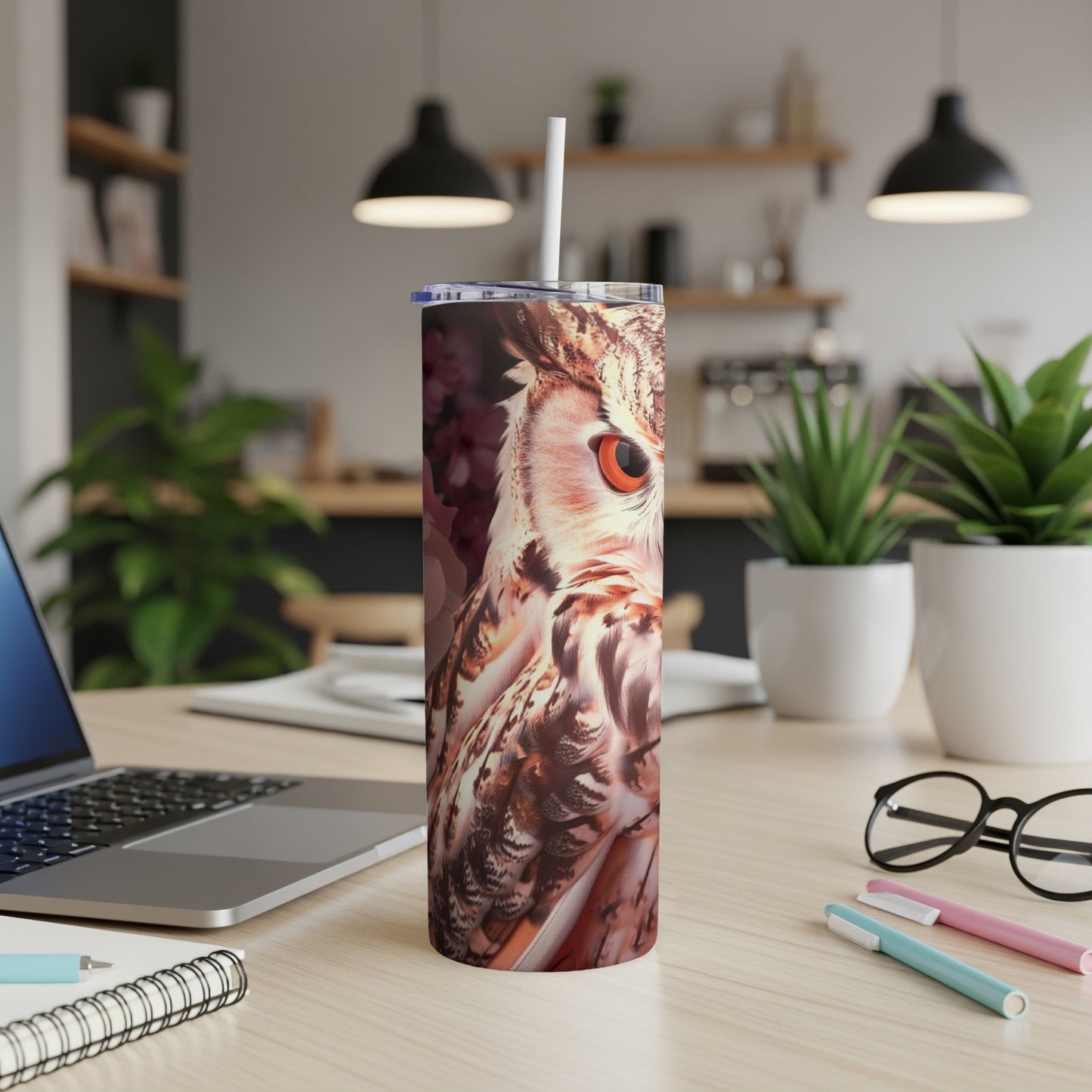 Owl illustration on a skinny tumbler with straw on a desk.