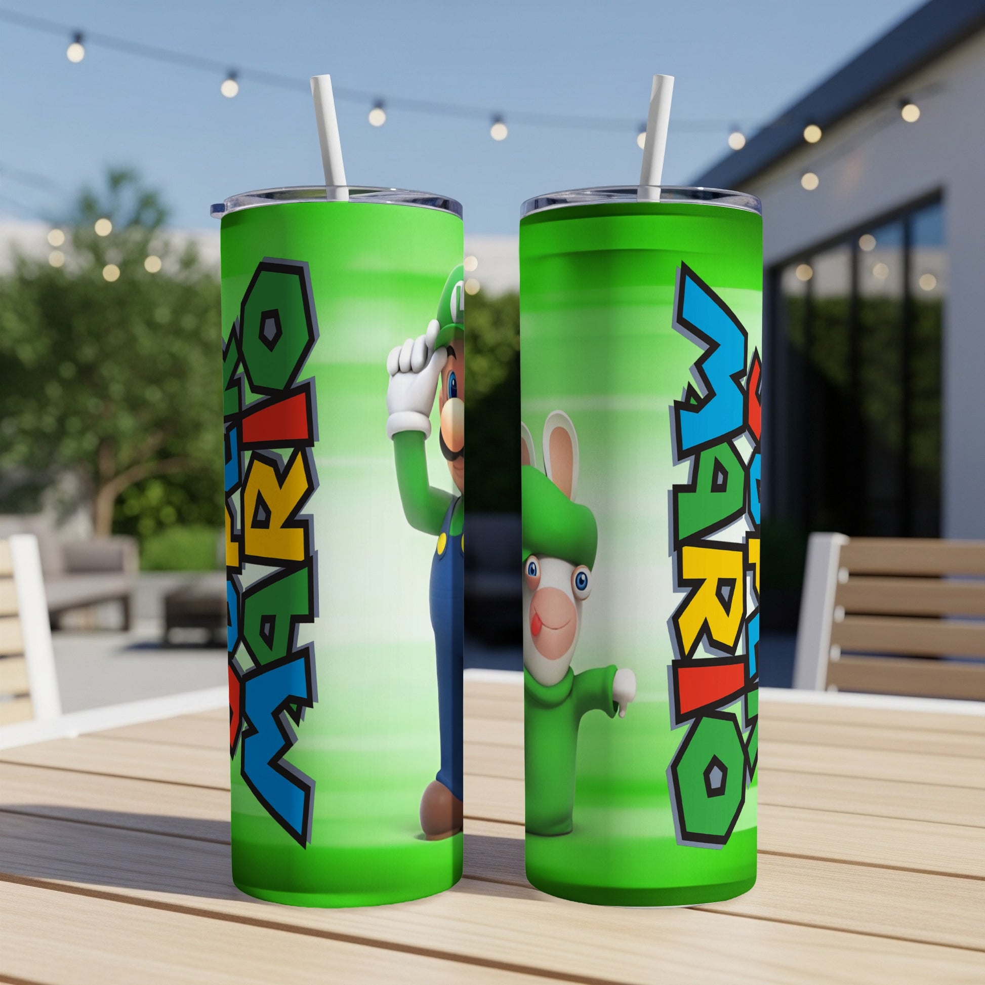Two Mario and Rabbids tumblers with straws on a wooden table.