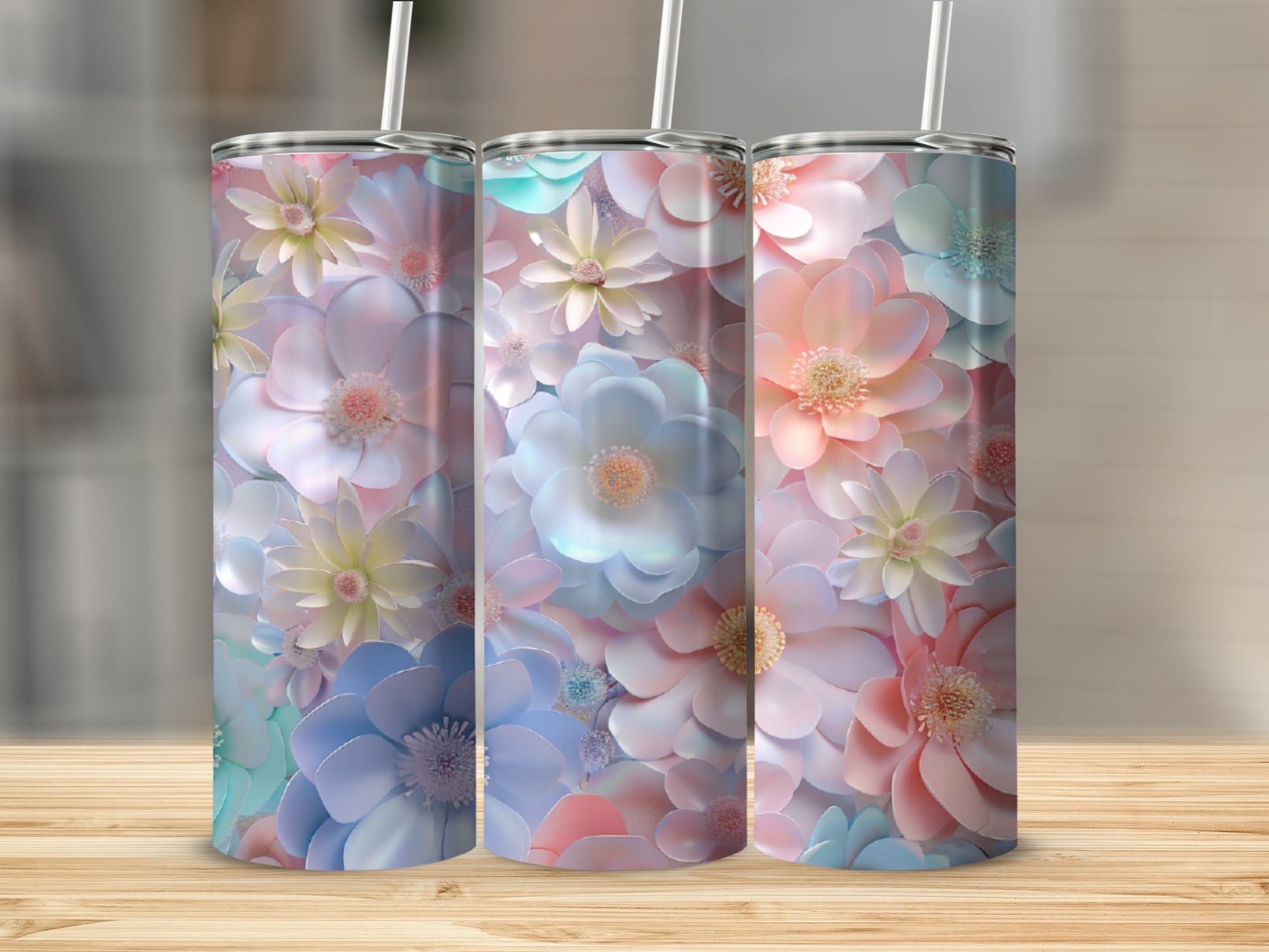 Three floral tumblers with pastel flowers and straws.