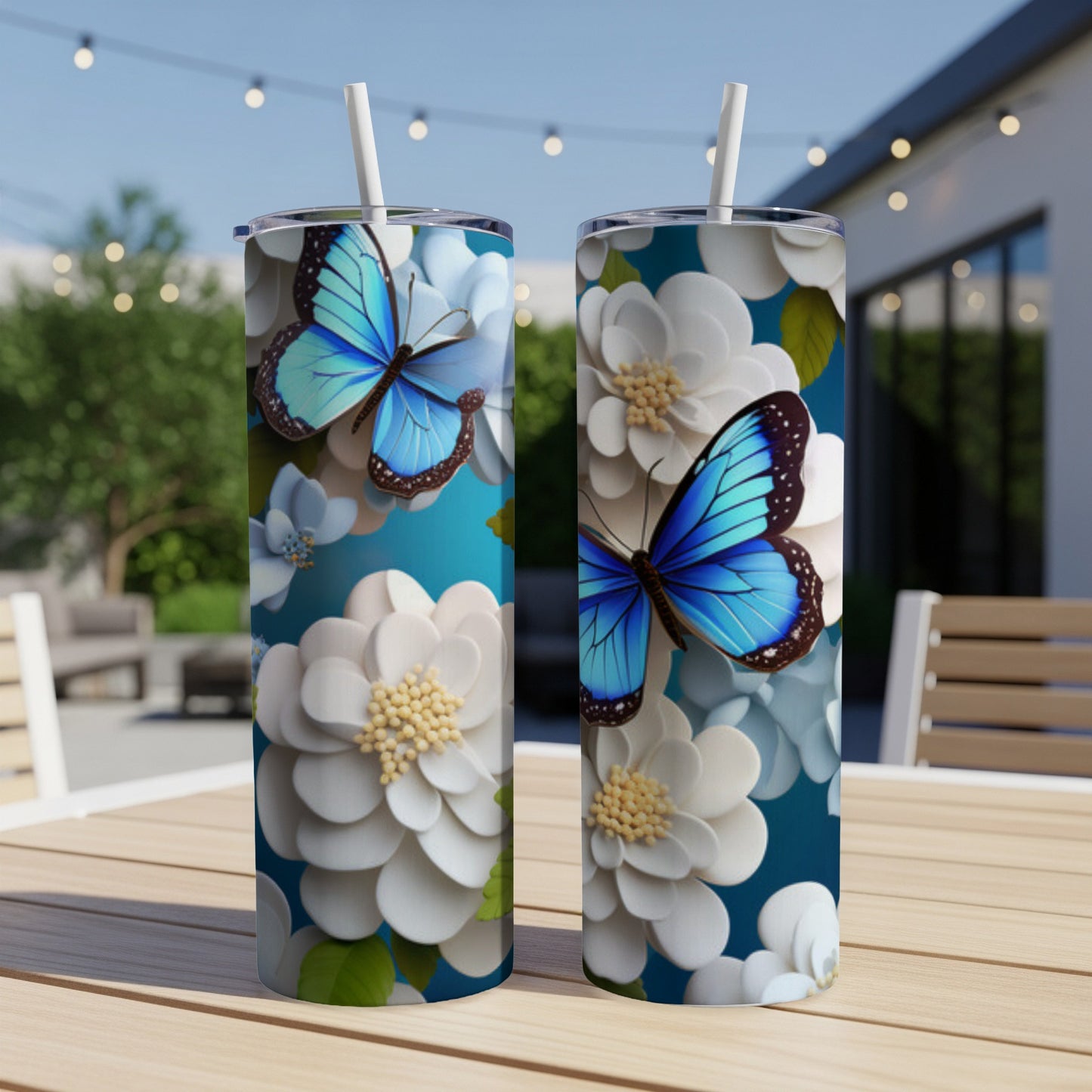 Blue butterfly on white flowers, two tumblers on table.
