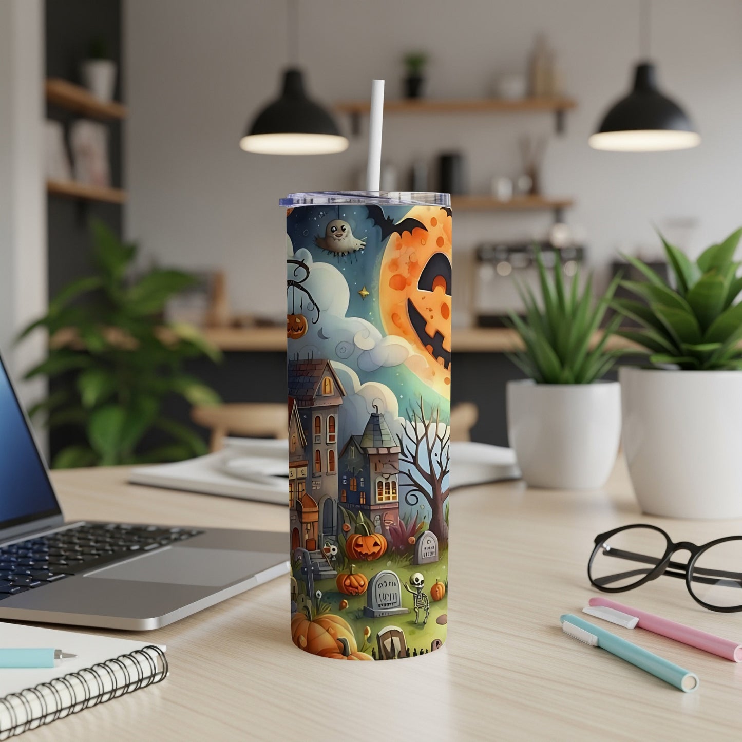 Tall tumbler with a Halloween village scene, including a pumpkin moon, ghosts, and bats.