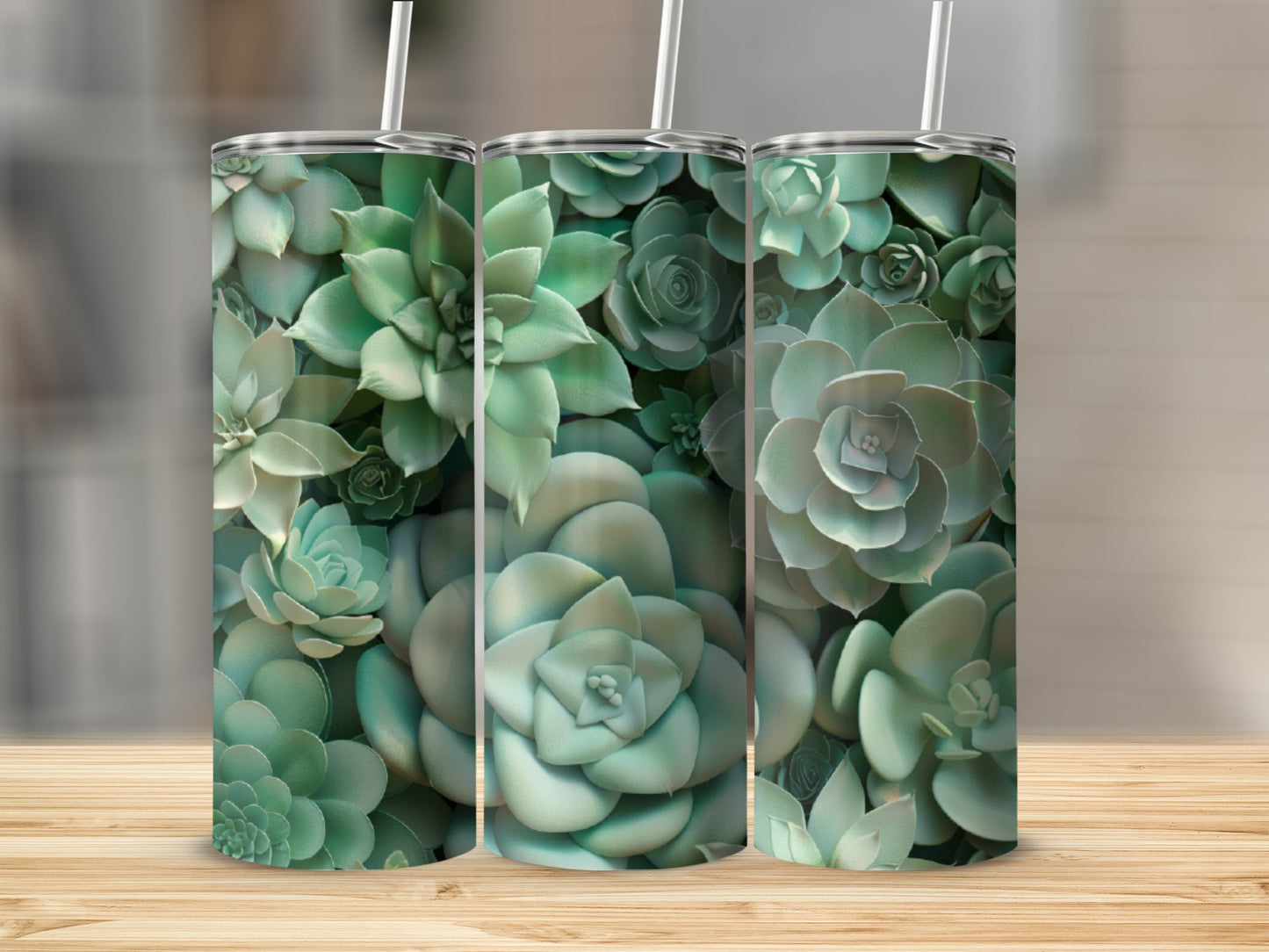 Three tumblers with a succulent plant pattern on a wooden surface.