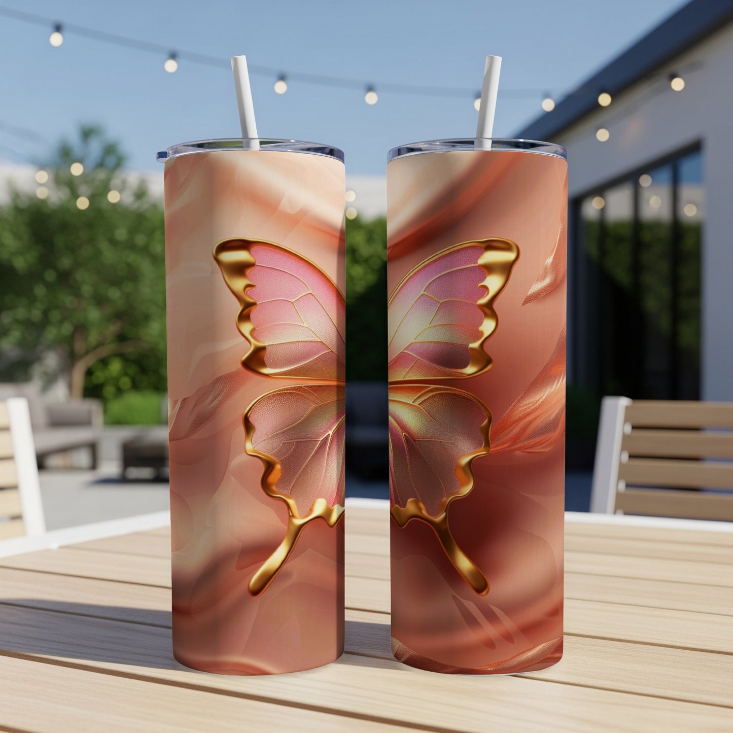 Two tumblers with iridescent butterfly wings design on a patio table.