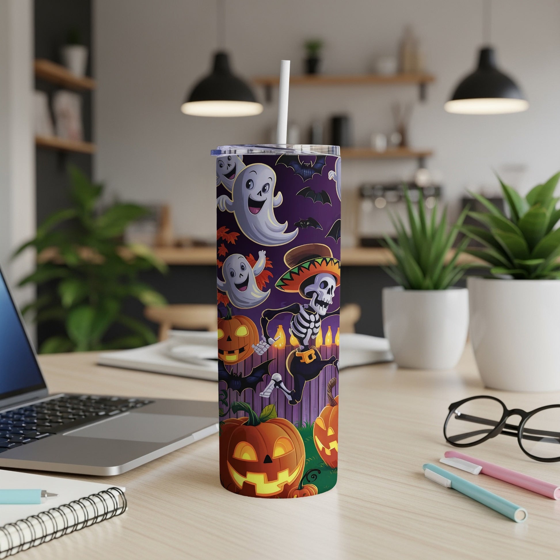 Halloween tumbler with ghosts, skeletons, bats, and jack-o'-lanterns on purple background.