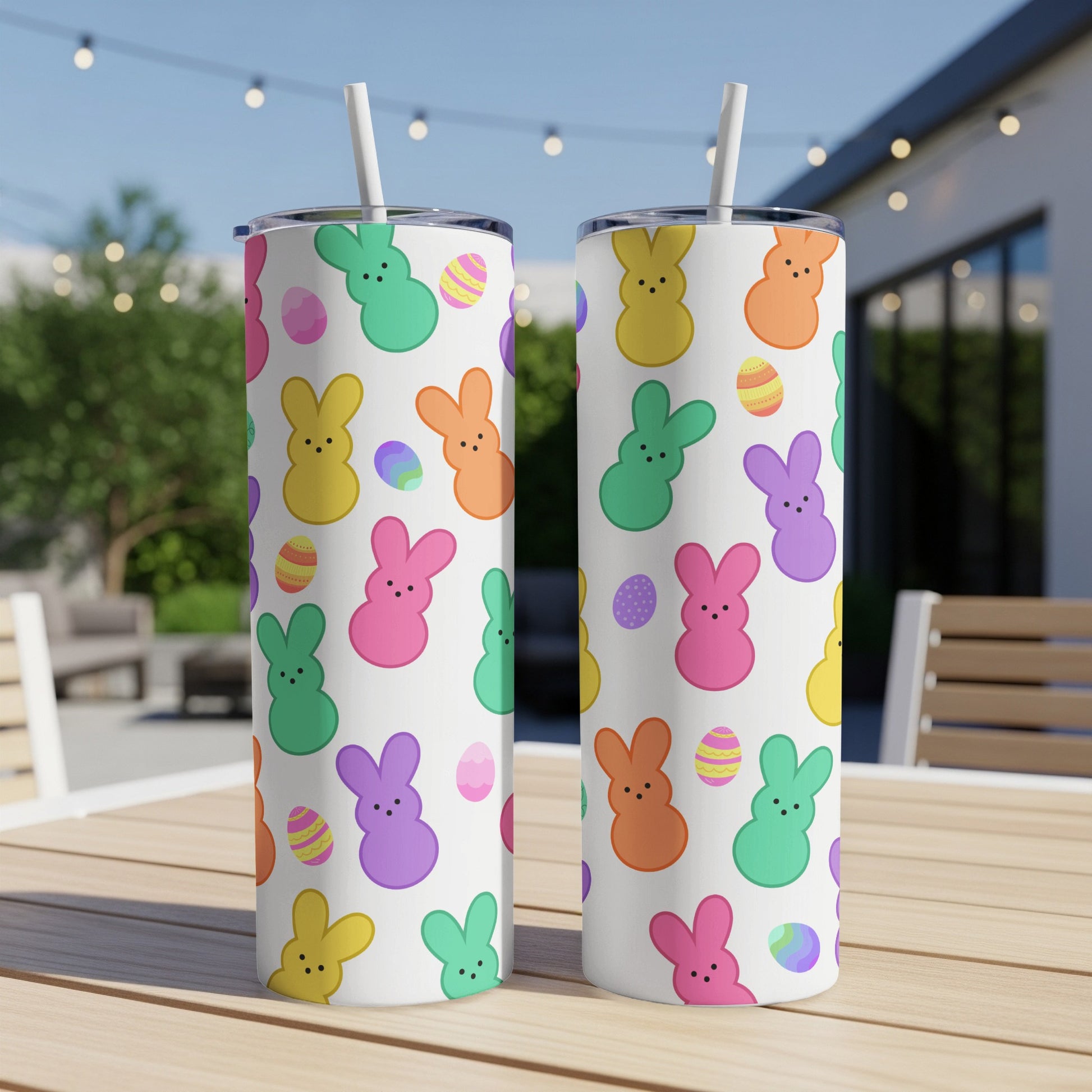 White tumblers with colorful Peeps bunnies and Easter eggs pattern.