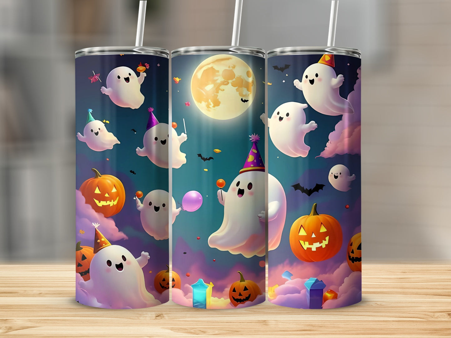 Three tumblers decorated with playful ghosts, jack-o'-lanterns, and a large full moon.
