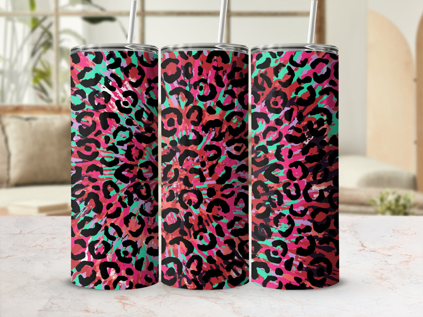 Three tumblers with a vibrant pink, red, and teal leopard print pattern.