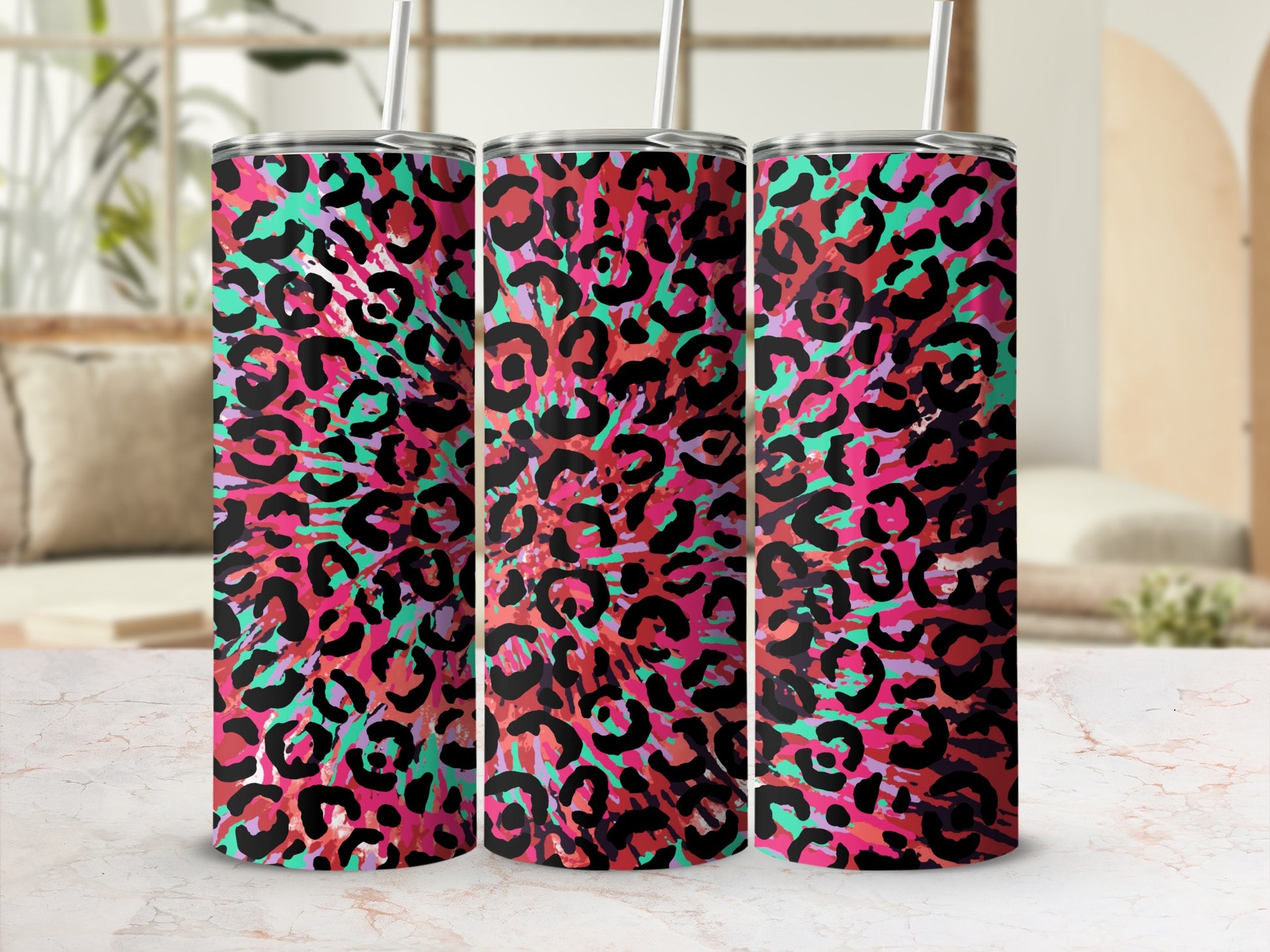 Three tumblers with a vibrant pink, red, and teal leopard print pattern.