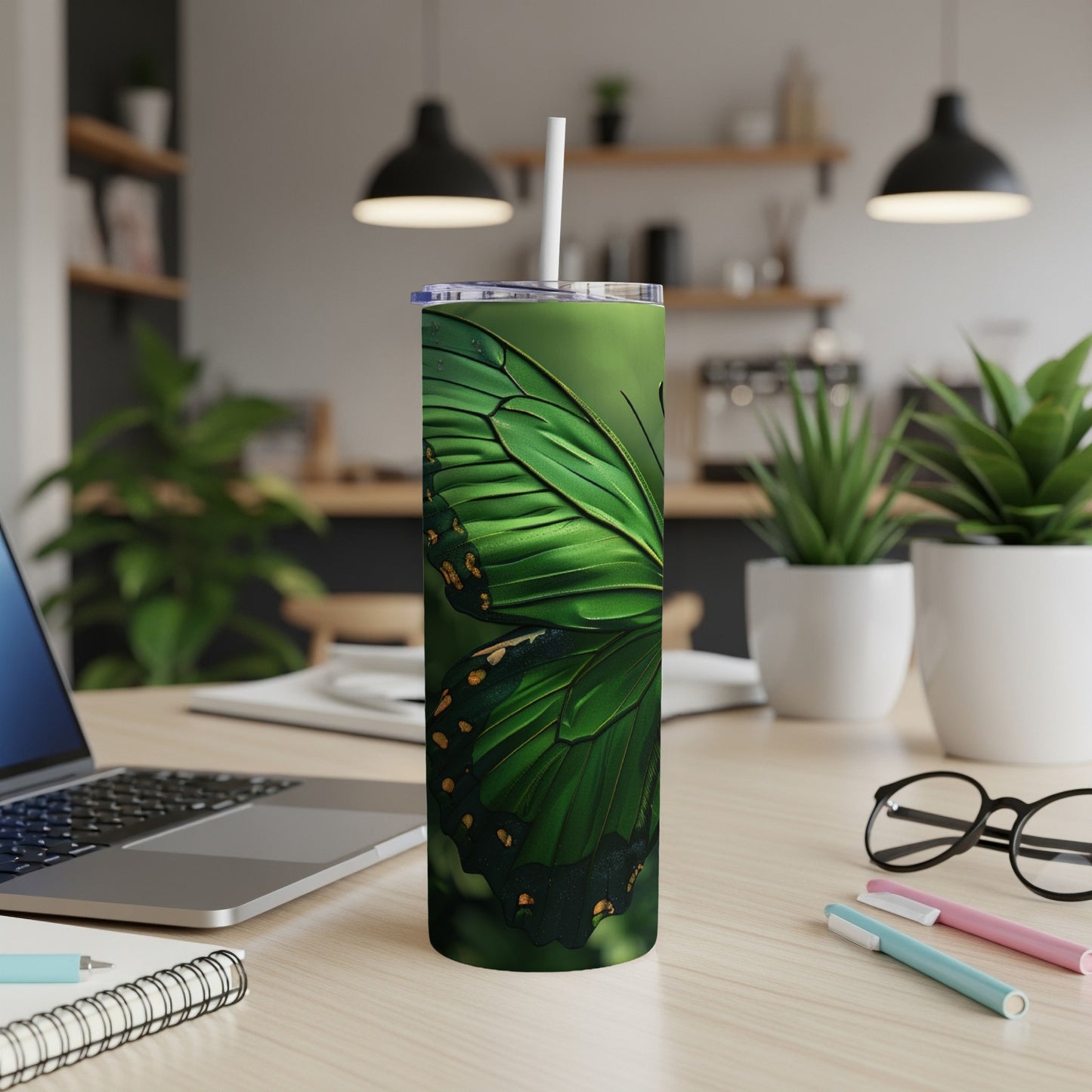 Green butterfly illustration on a stainless steel tumbler with a straw.