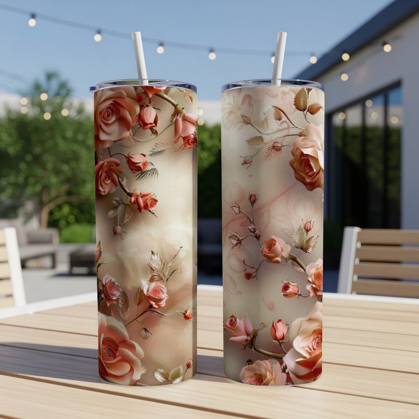 Two tumblers with coral and pink roses and vines on a blurred outdoor patio.