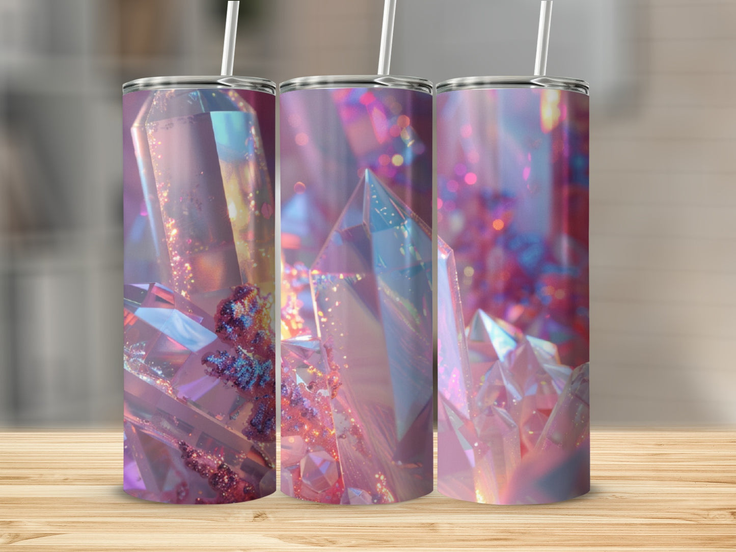 Three tumblers with iridescent crystal designs on a wooden surface.