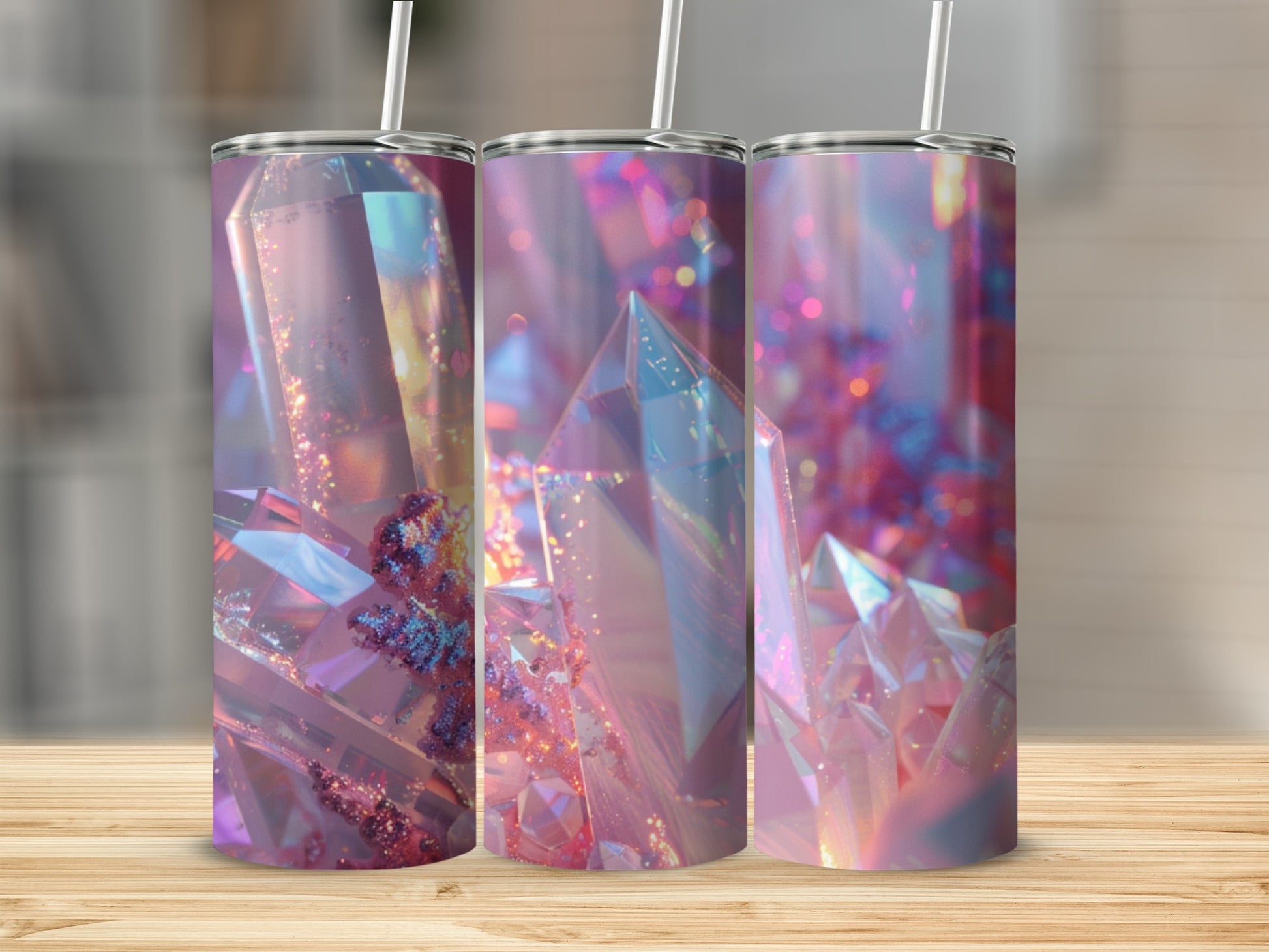 Three tumblers with iridescent crystal designs on a wooden surface.