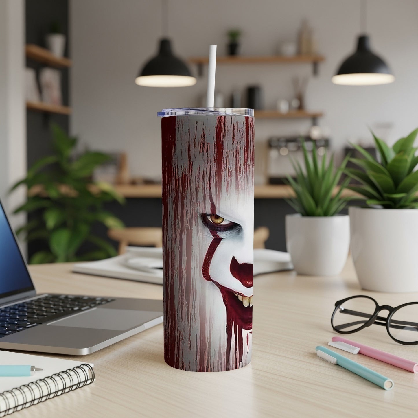 Tumbler with a creepy clown face and dripping red paint design.