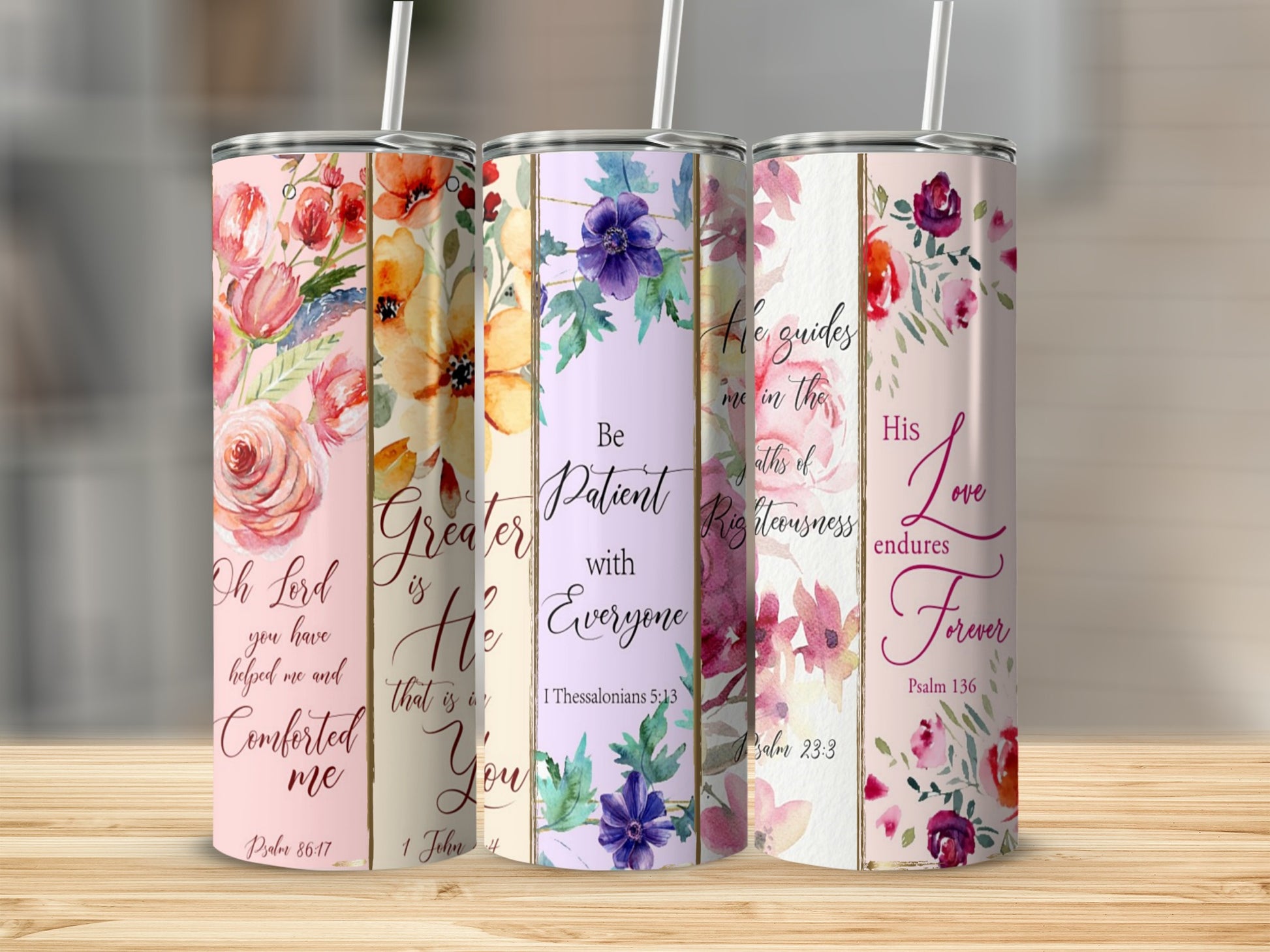 Three floral-patterned tumblers with Bible verses printed on them.