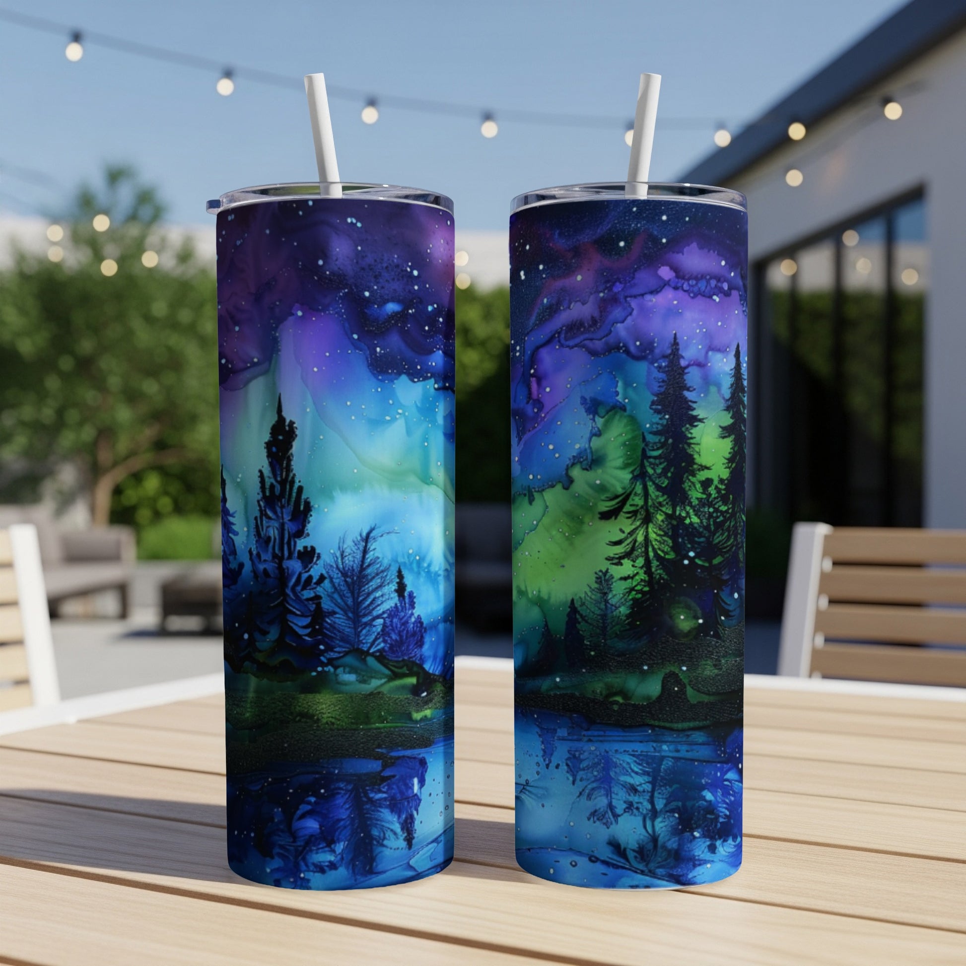 Two tumblers with starry night forest watercolor design.