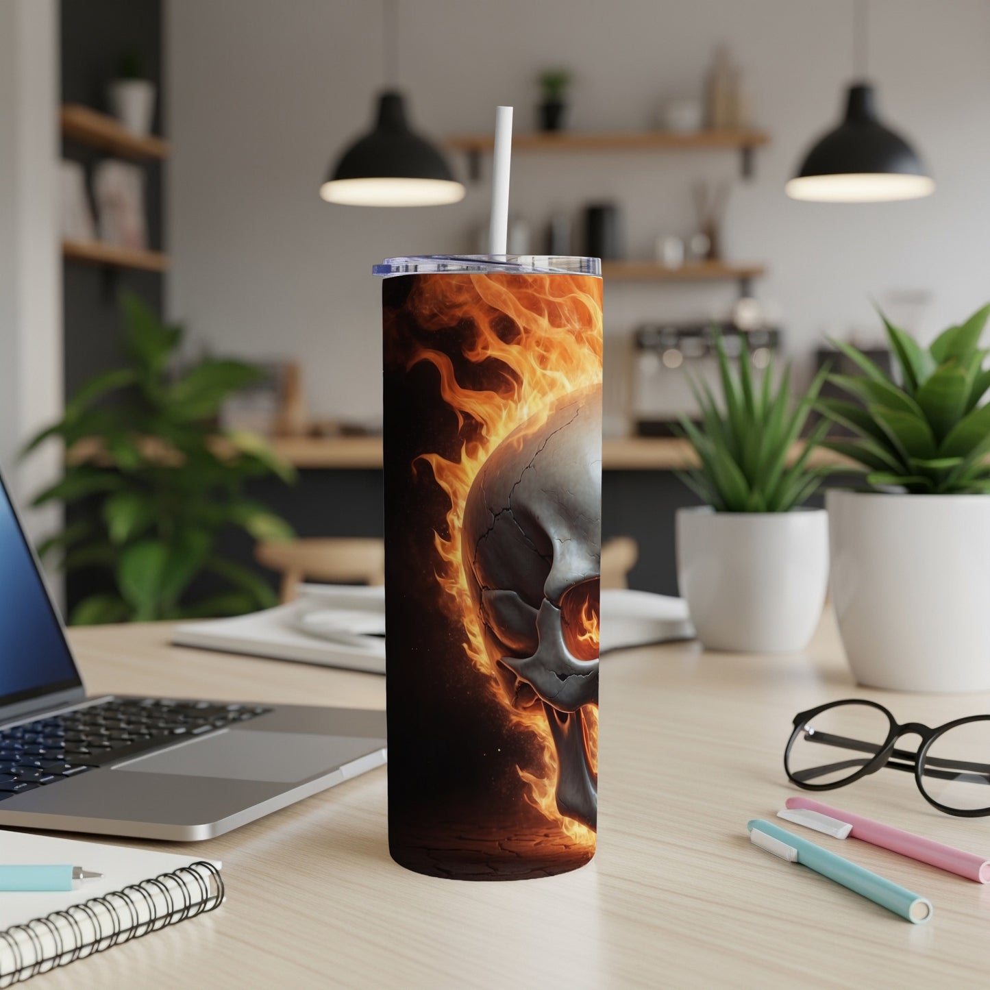 Flaming skull on a tumbler cup with a straw.