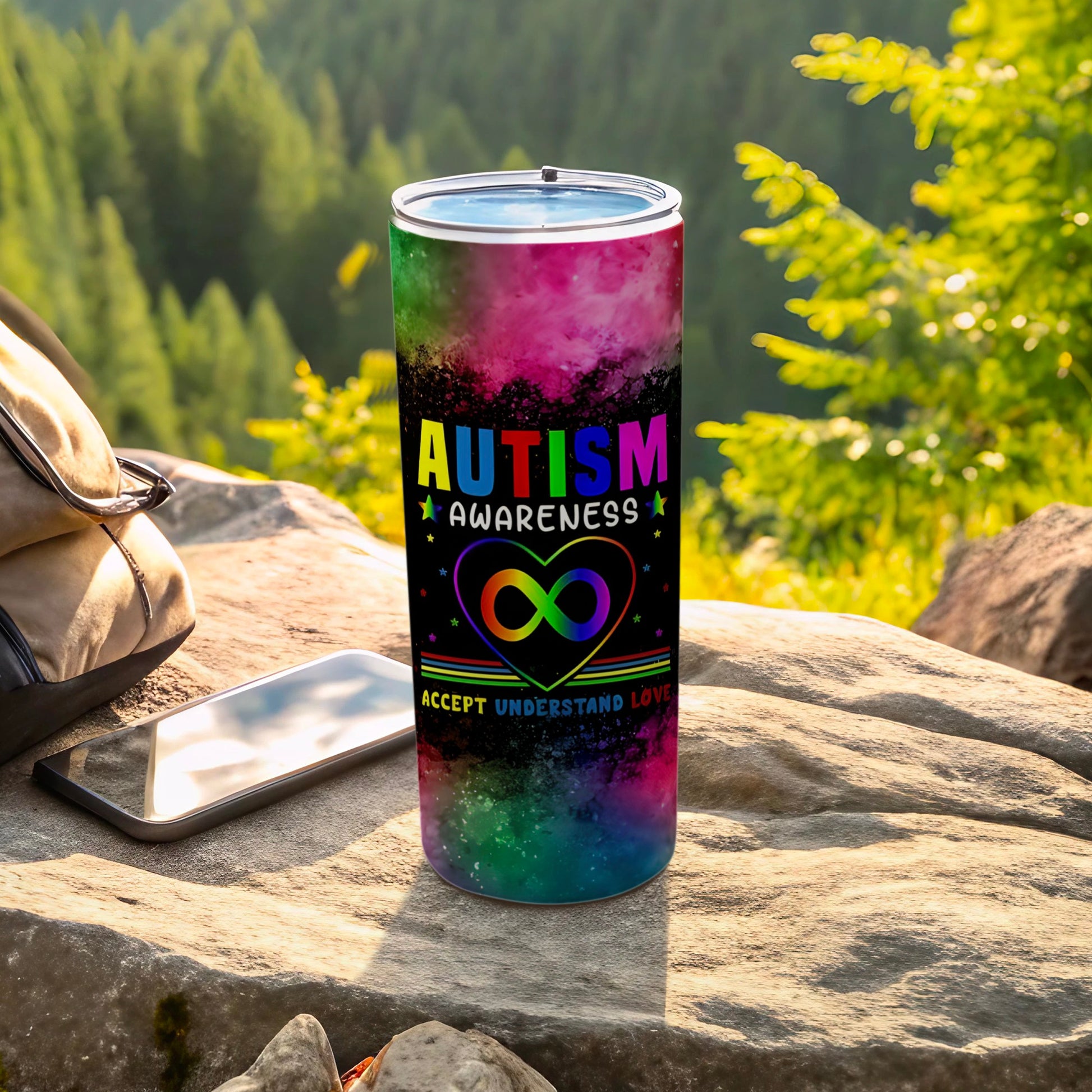 Autism awareness tumbler with rainbow infinity heart and text.