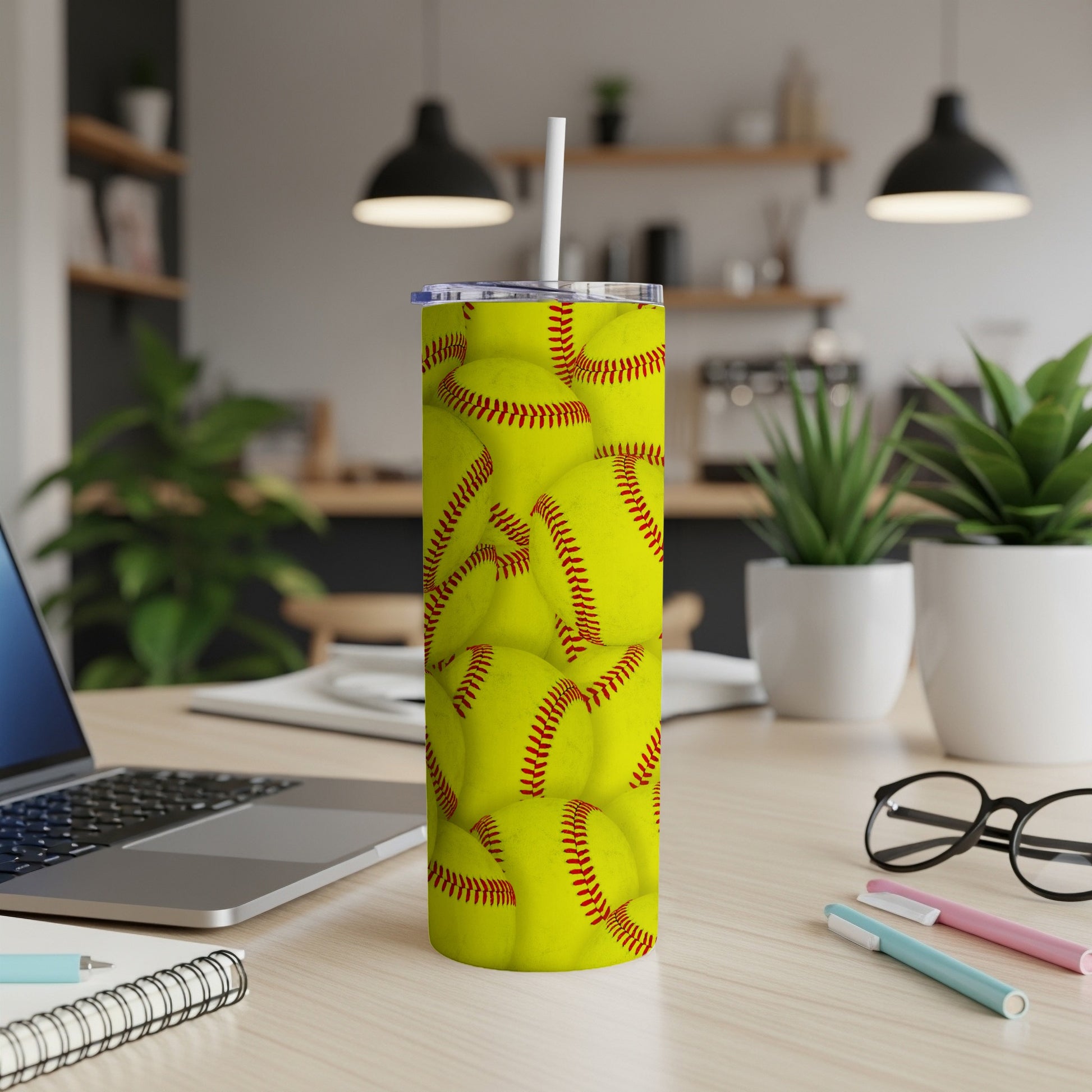 Yellow softball pattern on a white tumbler with a straw.