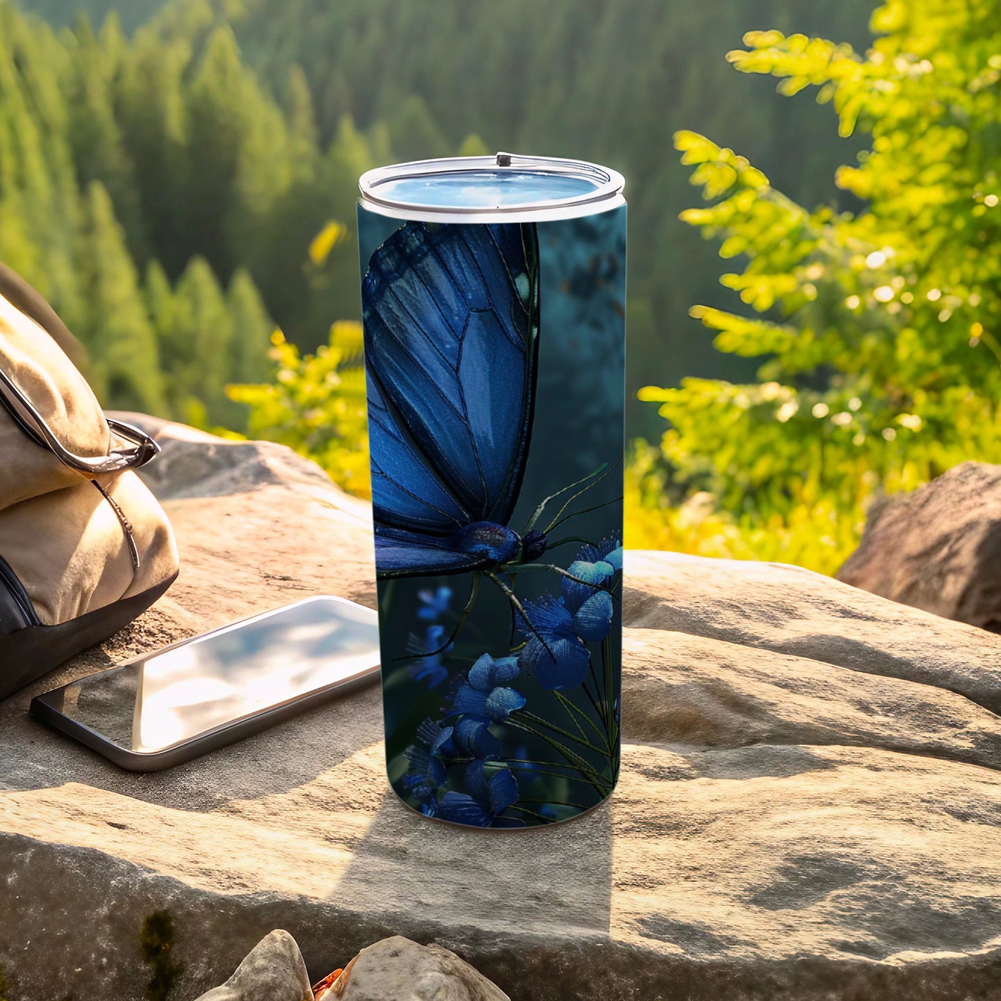 Blue butterfly on blue flowers on a travel tumbler outdoors.
