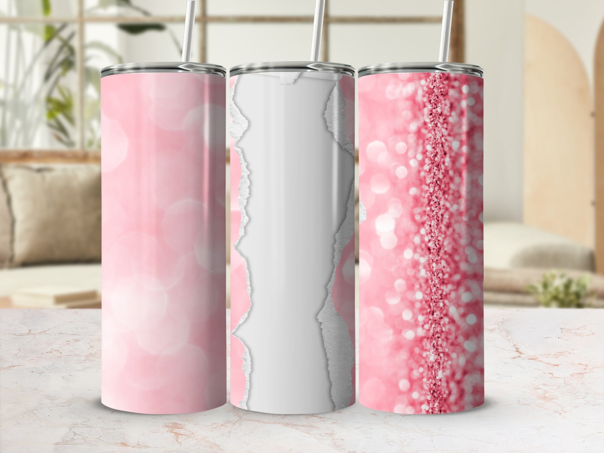 Three pink glitter tumblers with straws on a marble surface.