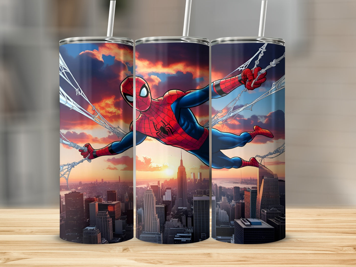 Spiderman swinging through a city at sunset, depicted on three tumblers.