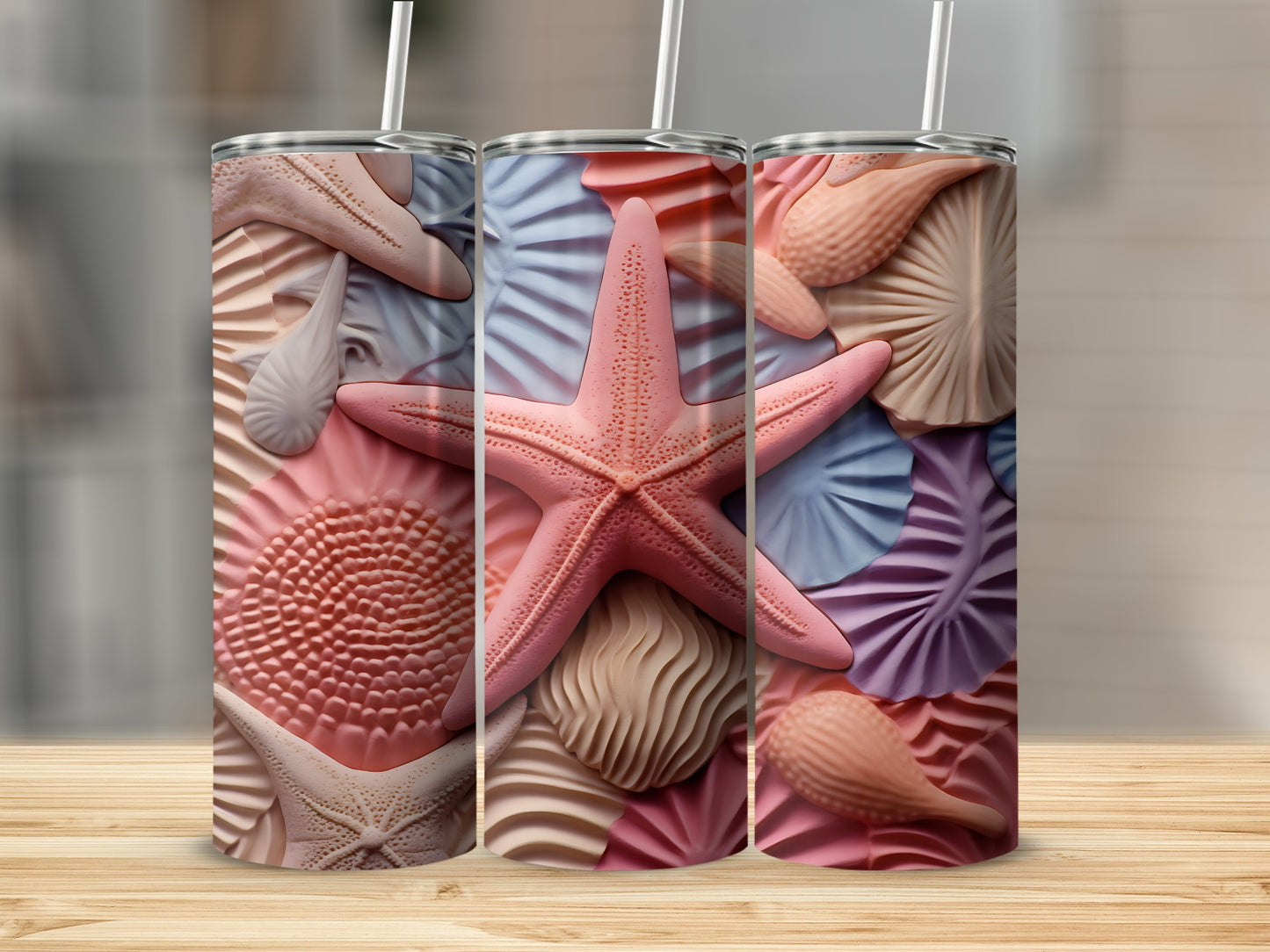 Three tumblers decorated with realistic pink starfish and seashell patterns.