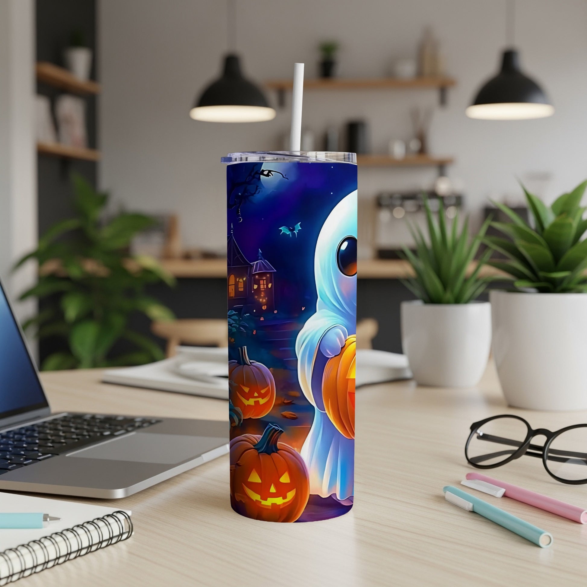 Halloween tumbler with a ghost, pumpkins, and haunted house design.