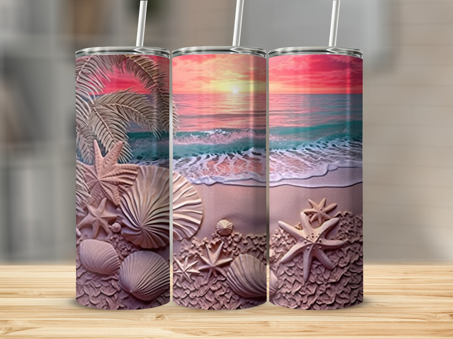 Three tumblers with beach scene and seashell designs.