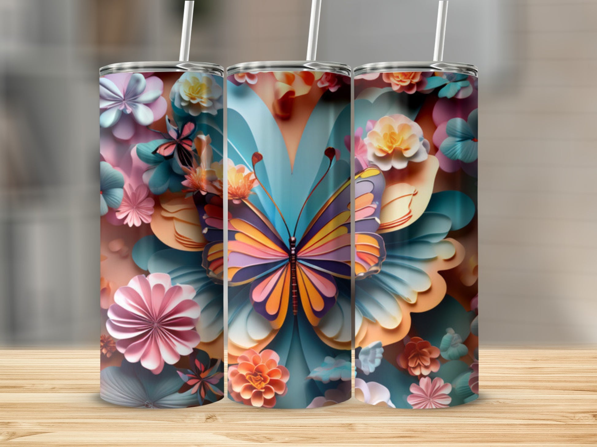 Colorful butterfly and floral pattern on three tumblers.