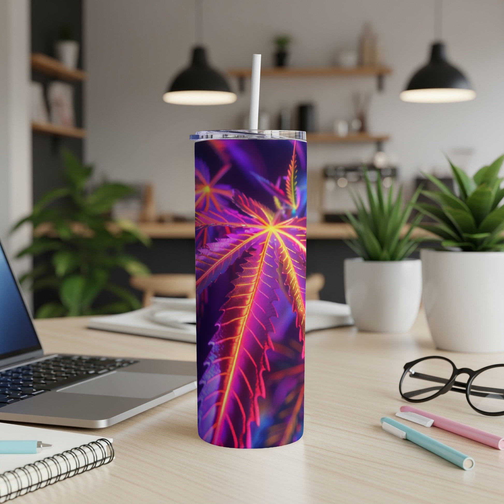 Purple and orange cannabis leaf pattern on a tall, slim tumbler with a straw.