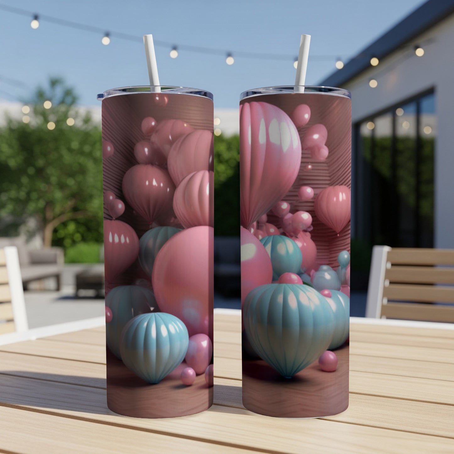Two tall tumblers with pastel pink and blue balloons against a wooden background.