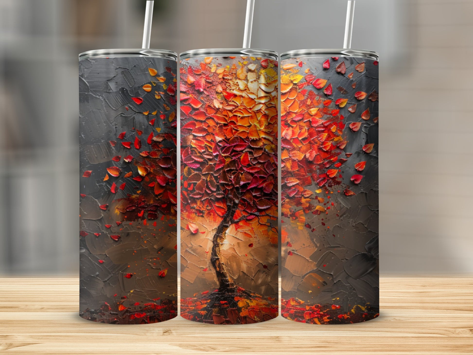 Tumbler with textured abstract art of a tree with red and orange falling leaves.
