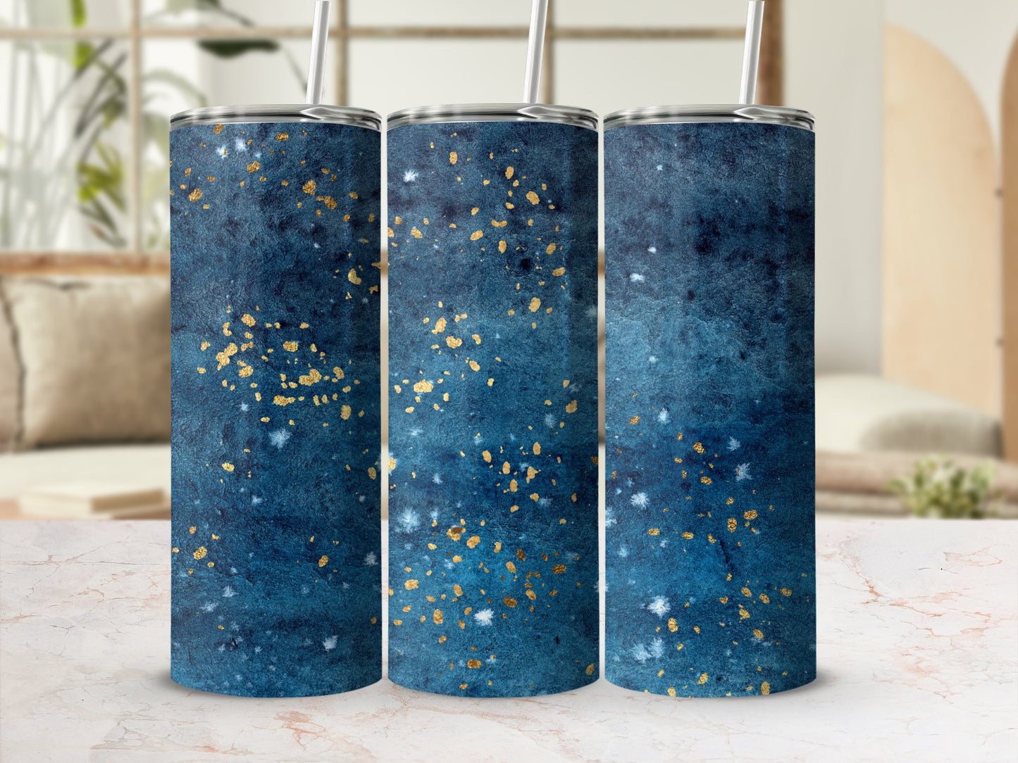 Three tumblers with a dark blue and gold speckled watercolor design.