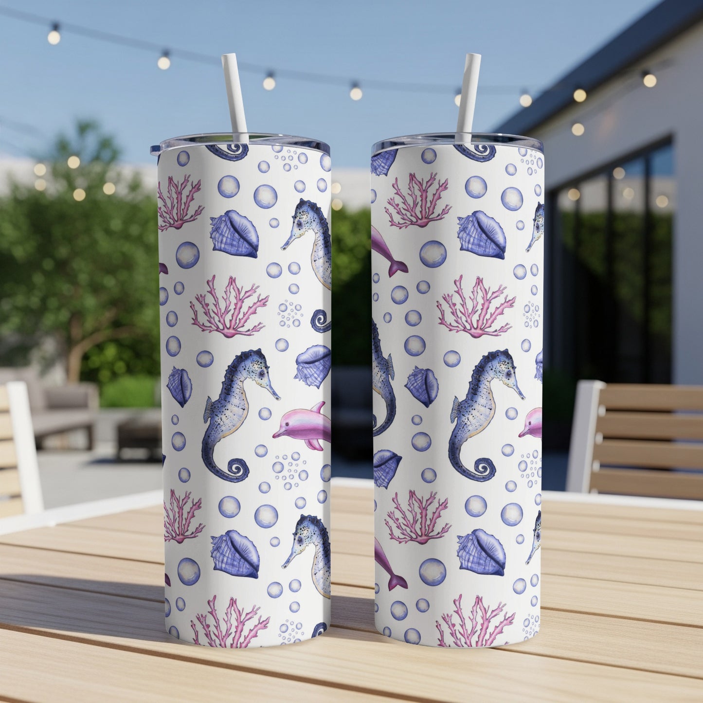 Two tumblers with seahorses, dolphins, shells, and coral on white speckled background.