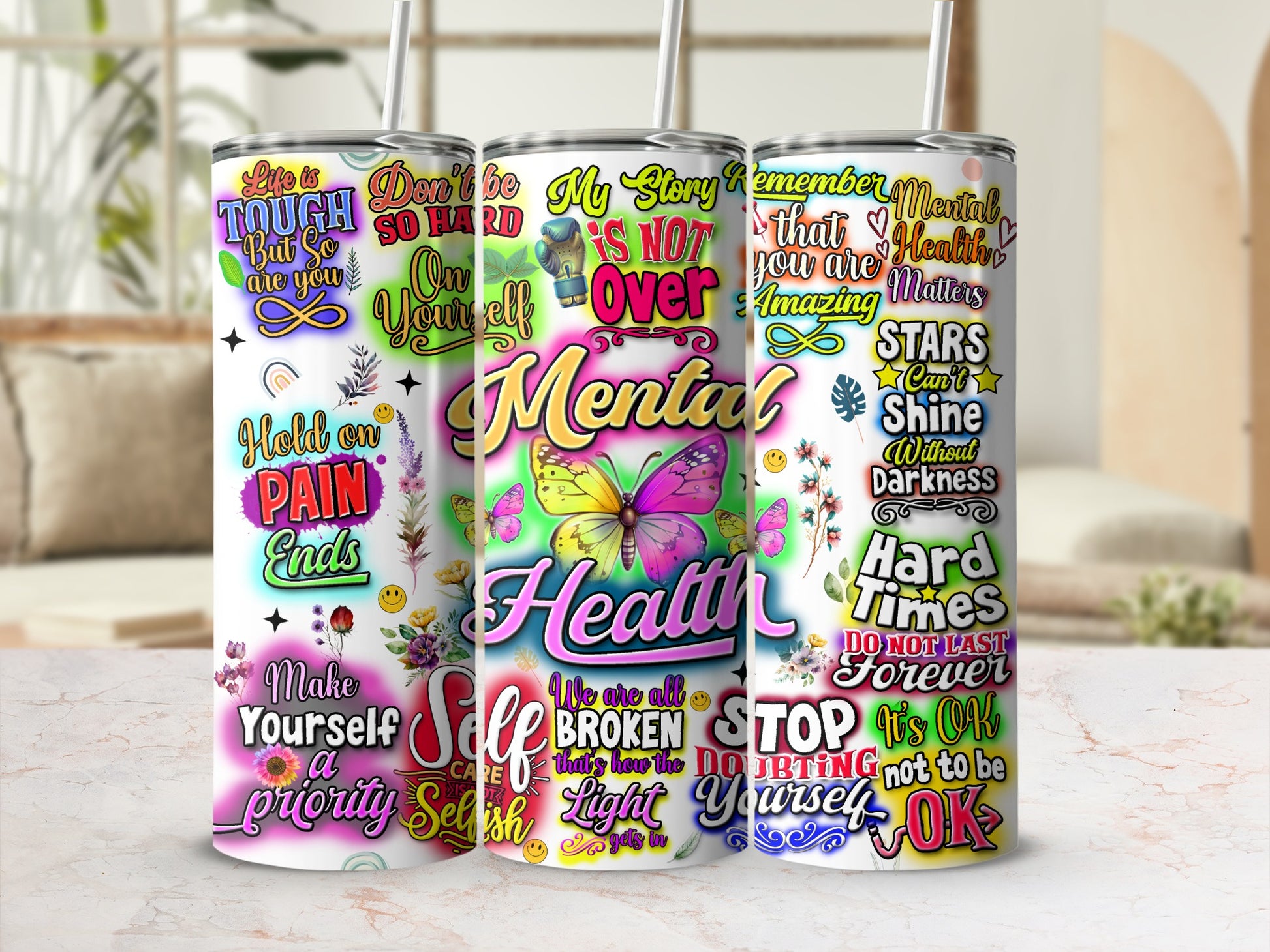 Three tumblers with mental health and self-care quotes, one with butterflies.