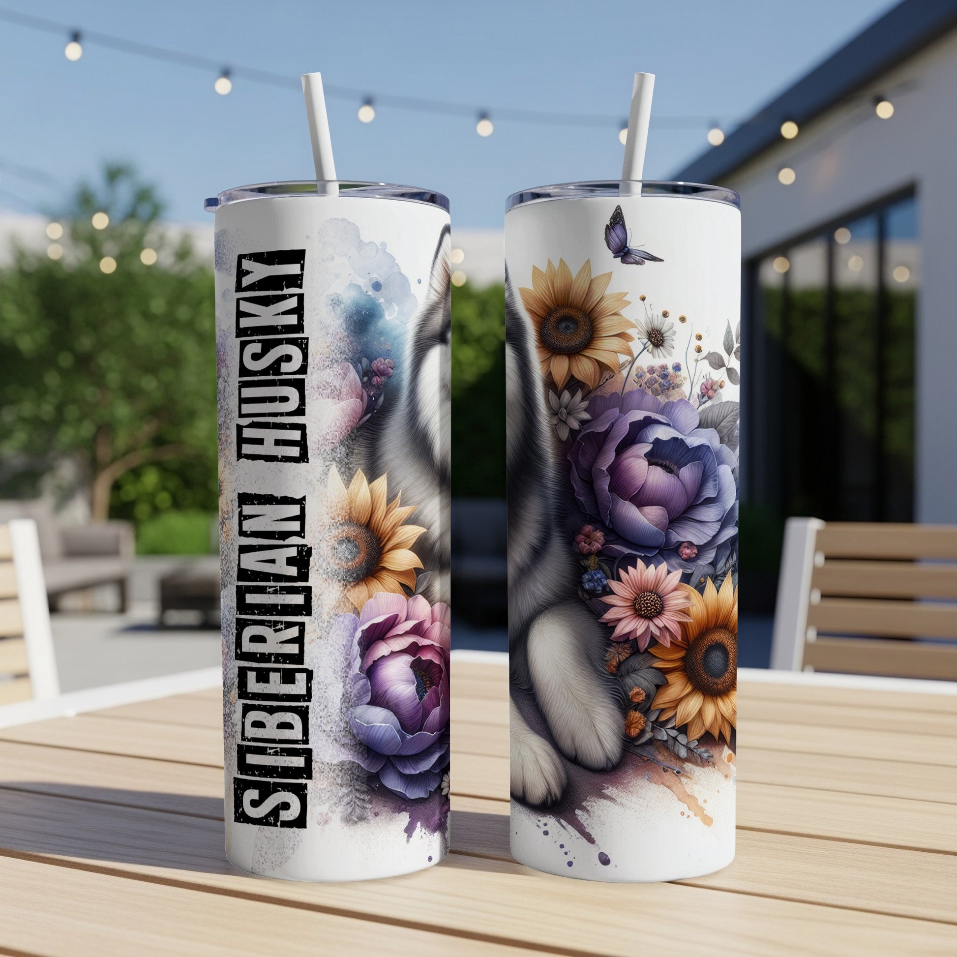 Two tumblers with Siberian Husky and floral design on outdoor table.