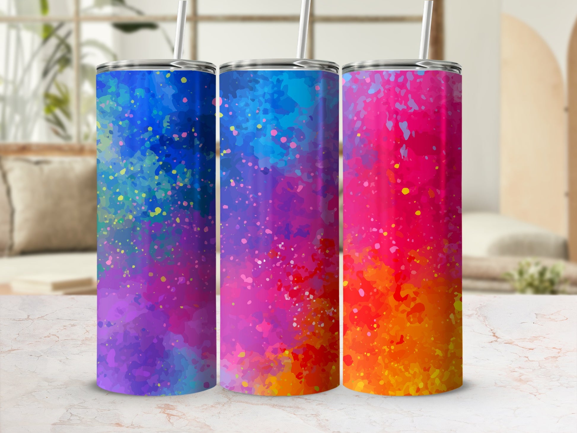 Three tumblers with colorful abstract splatter designs in blue, pink, and orange gradients.